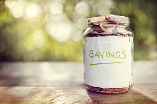 Savings money jar full of coins concept for saving or investment for a house, retirement or education