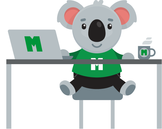 MIG mascot sitting at desk